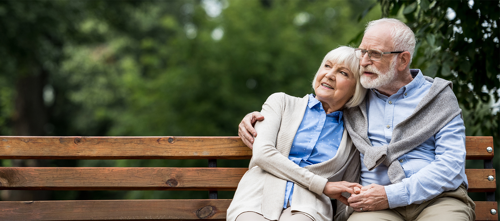 Senior couple sitting on park bench